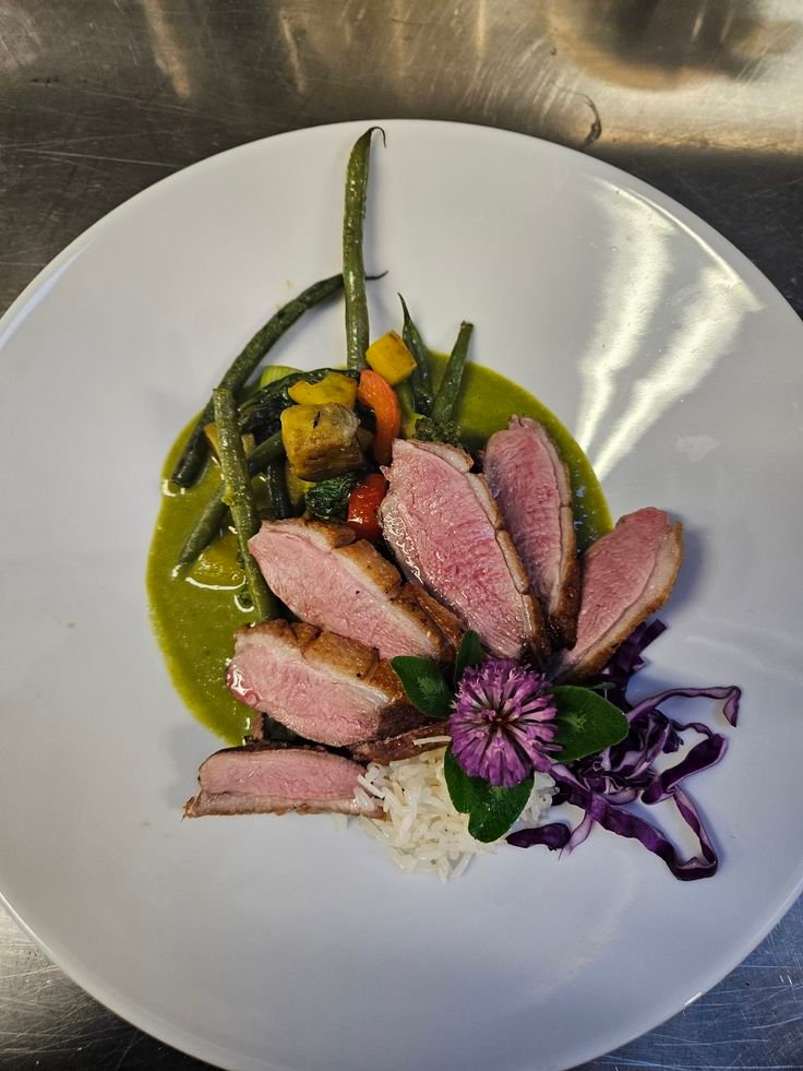 Duck dish with asparagu, squash and carrots.